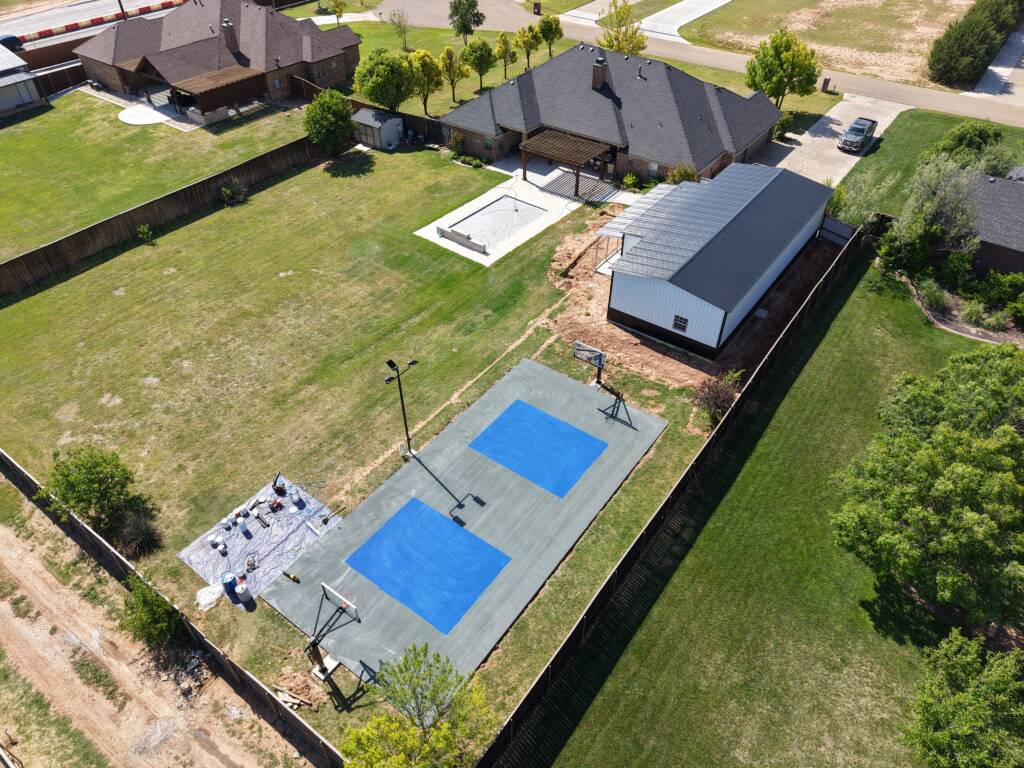 Backyard pickleball court with acrylic hard court surface and LED lighting in Lubbock, TX backyard multi-sport court West Texas