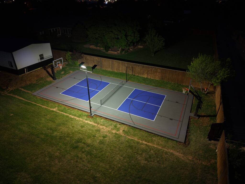Backyard pickleball court with acrylic hard court surface and LED lighting in Lubbock, TX