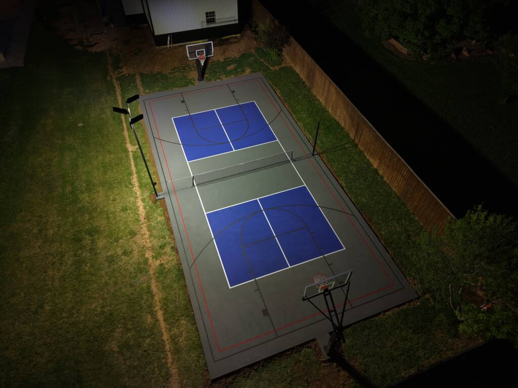 Backyard pickleball court with acrylic hard court surface and LED lighting in Lubbock, TX