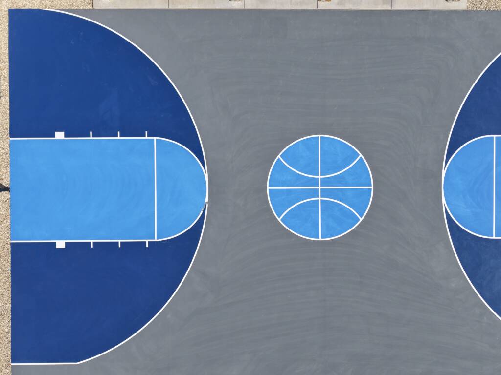 Backyard pickleball court with acrylic hard court surface and LED lighting with a race track in Lubbock, TX