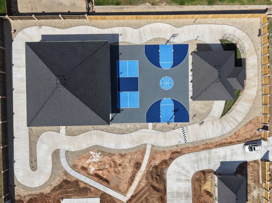 Backyard pickleball court with SnapSports surface and LED lighting with a race track in Lubbock, TX